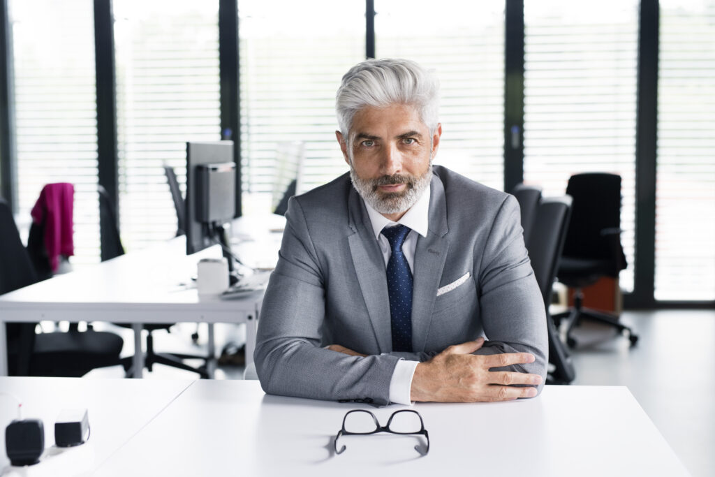 mature businessman in gray suit in the office.