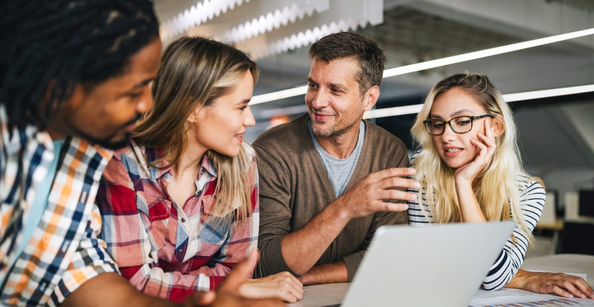 group of business people and software developers working as a team in office