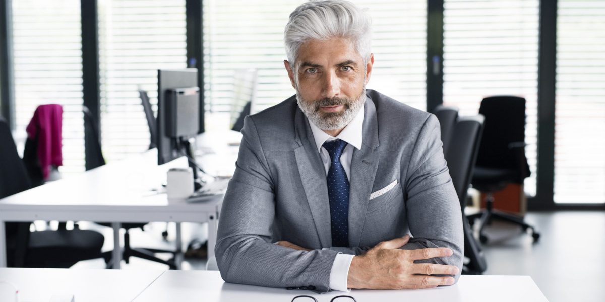 mature businessman in gray suit in the office.